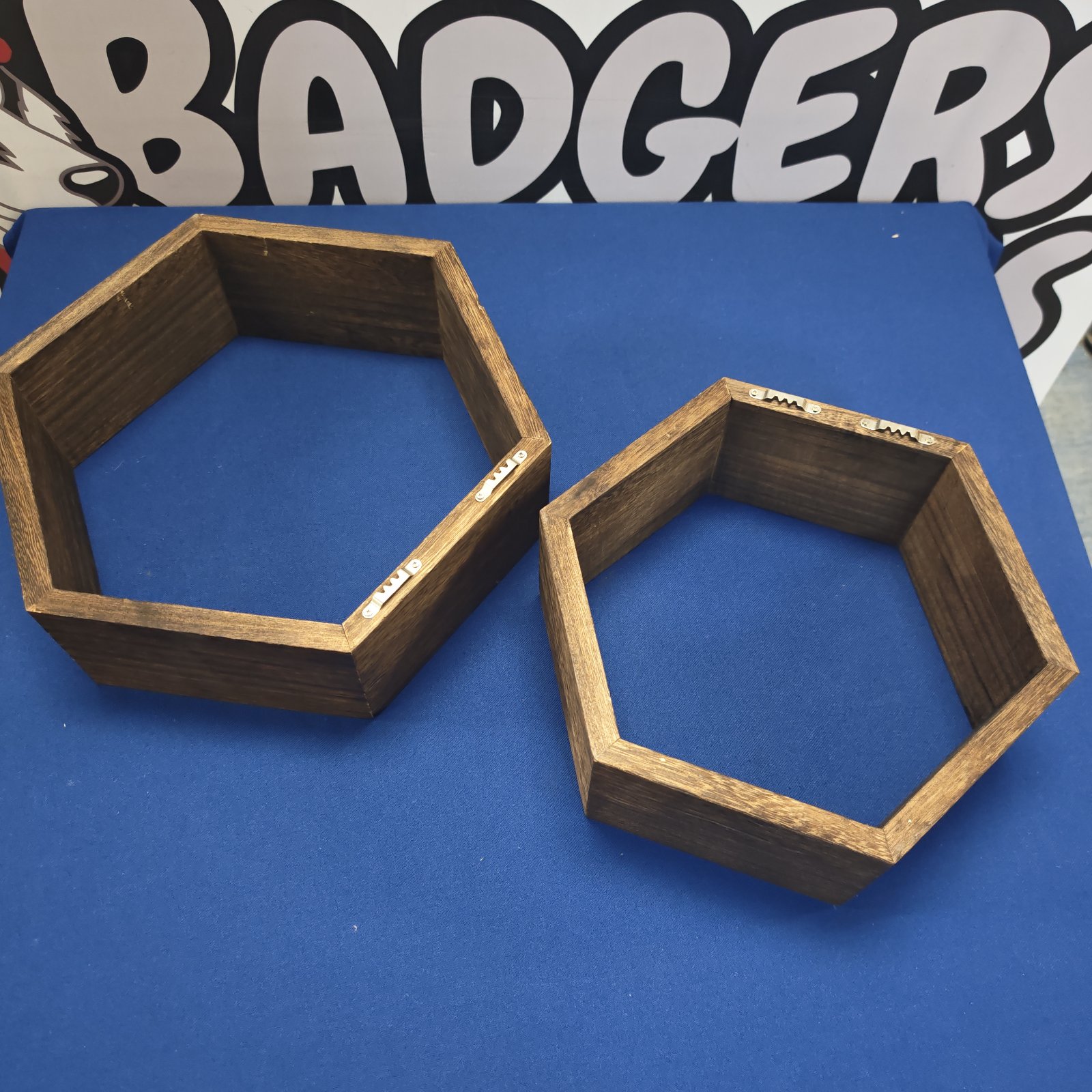 Dark wood hexagonal wall shelves for modern home decor.