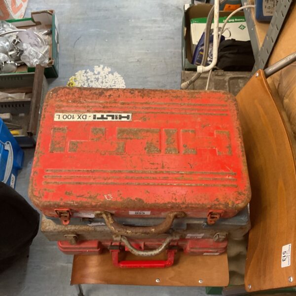 Vintage Hilti DX 100 L powder actuated tool in a red case.
