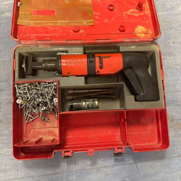 Hilti DX400 nail gun with case, showing signs of use.