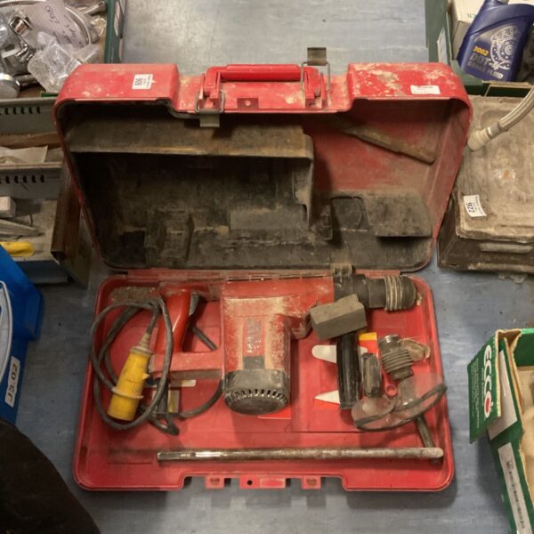 Red Hilti rotary hammer drill in open carrying case.