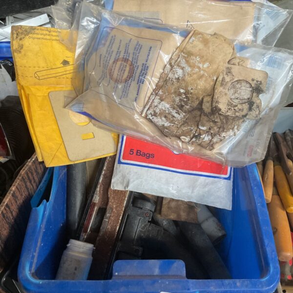 Vintage Hoover vacuum cleaner bags and attachments in a box.