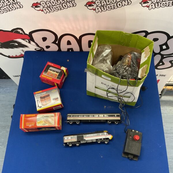 Hornby model railway accessories and carriages in a box.