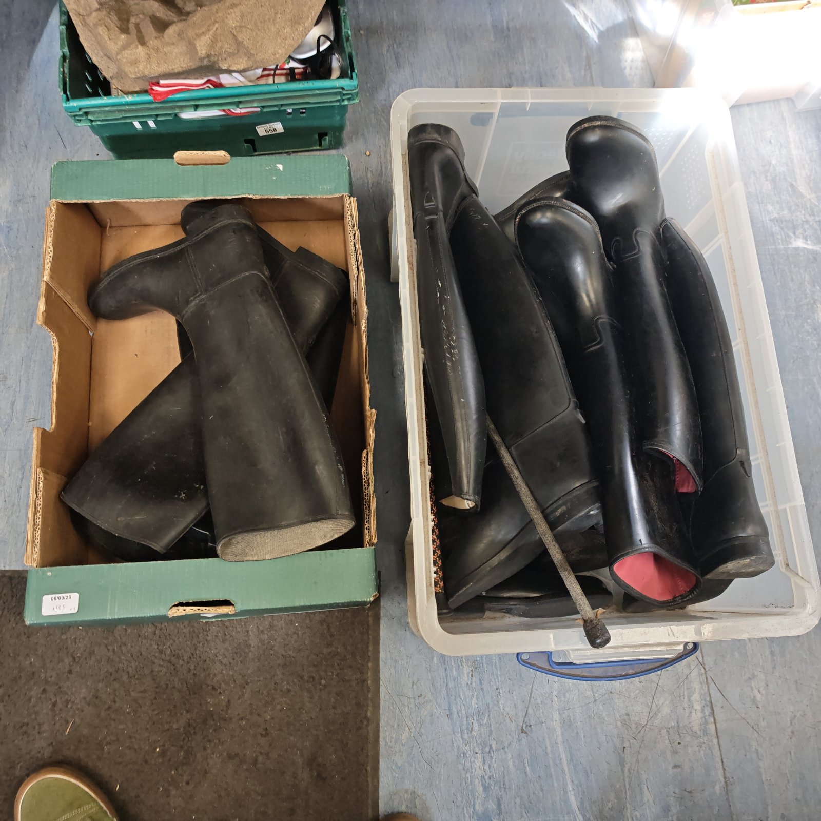 Vintage horse riding boots and crops in a box.
