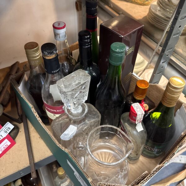 House clearance lot of alcohol bottles and glassware.
