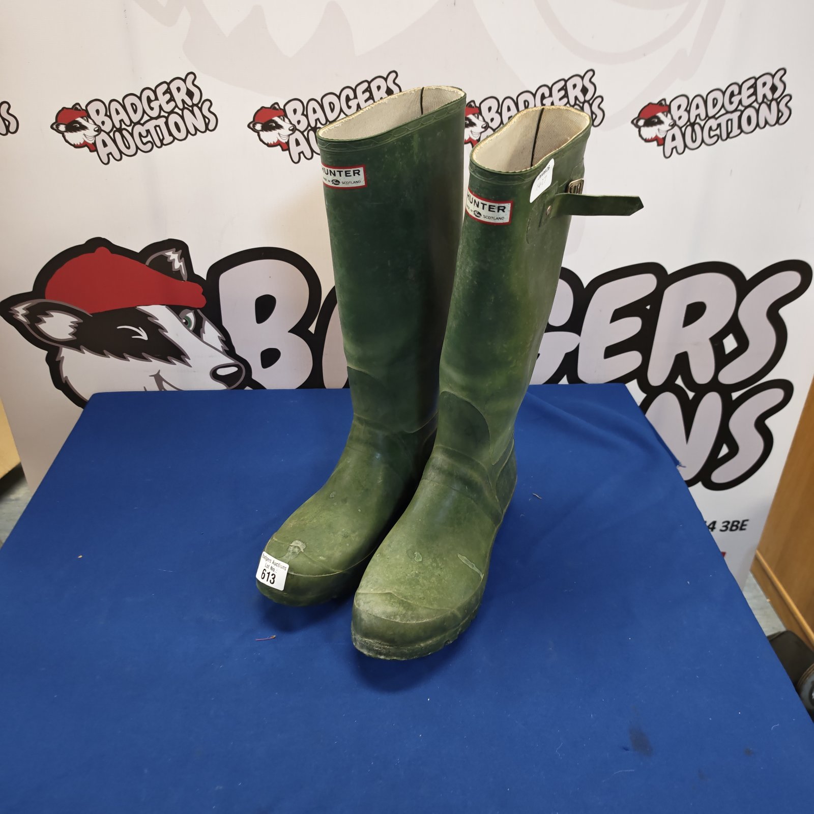 Green Hunter Wellington boots size 11, showing signs of wear.