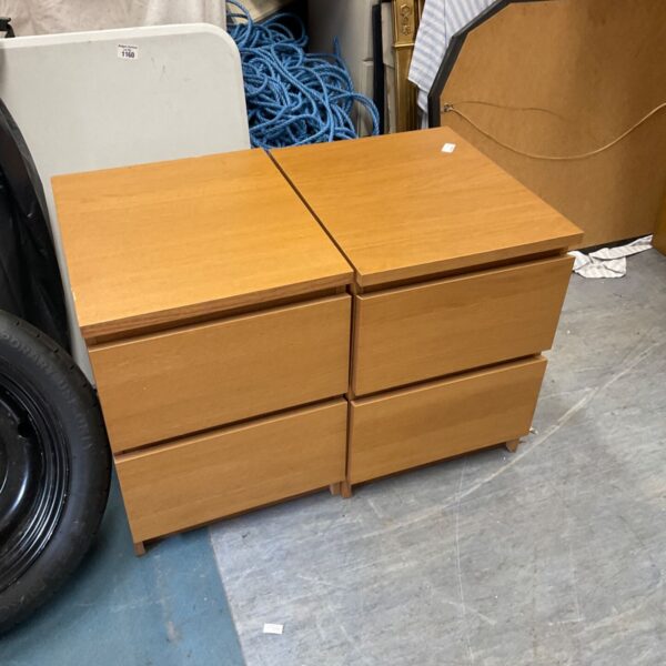 Pair of wooden Ikea bedside cabinets with two drawers.