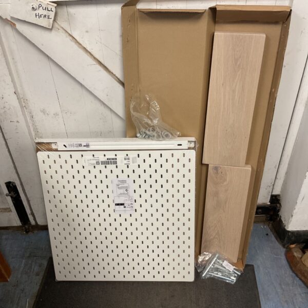 Ikea pegboard and oak floating shelves for wall organization.