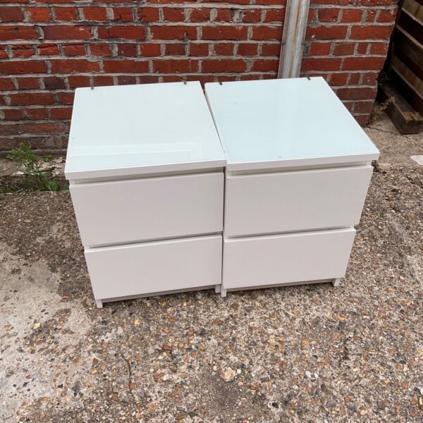 White Ikea bedside cabinets, a pair of small bedroom storage units.