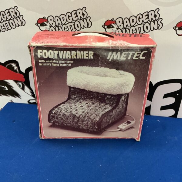 Vintage IMetec footwarmer with colourful patterned cover.