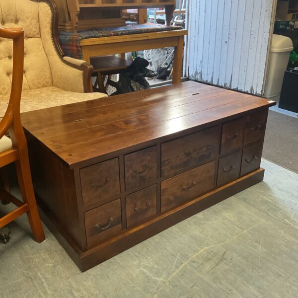 Rustic Indian oak coffee table with ten drawers for storage.