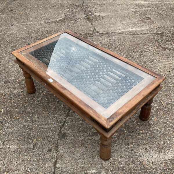 Indian oak coffee table with iron lattice and glass top.