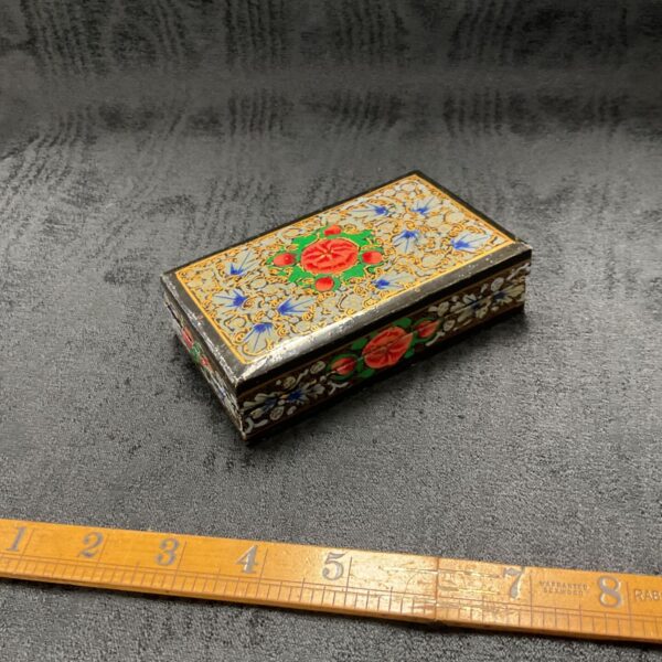 Hand-painted Indian trinket box with colourful floral designs.