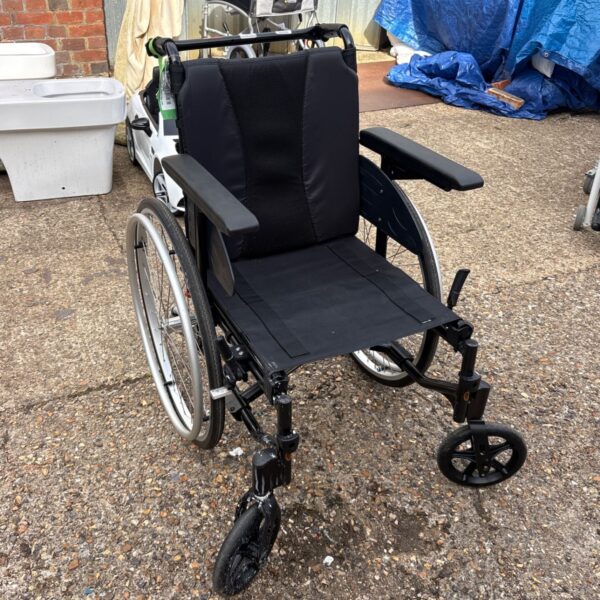 Black Invacare folding wheelchair with chrome frame.