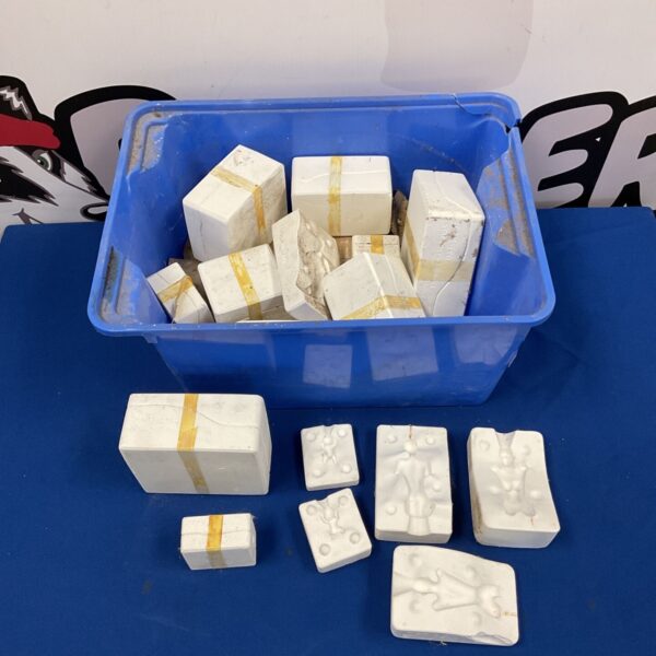 Blue bin filled with vintage J Wolf plaster doll moulds.