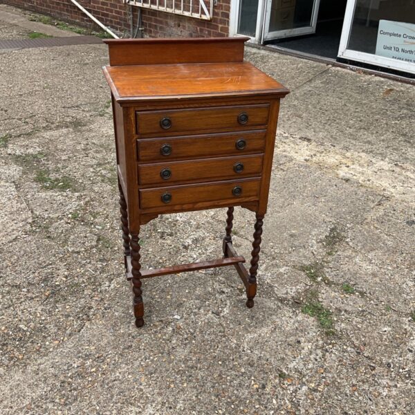 Antique Jacobean cabinet with four drawers, a classic storage solution.