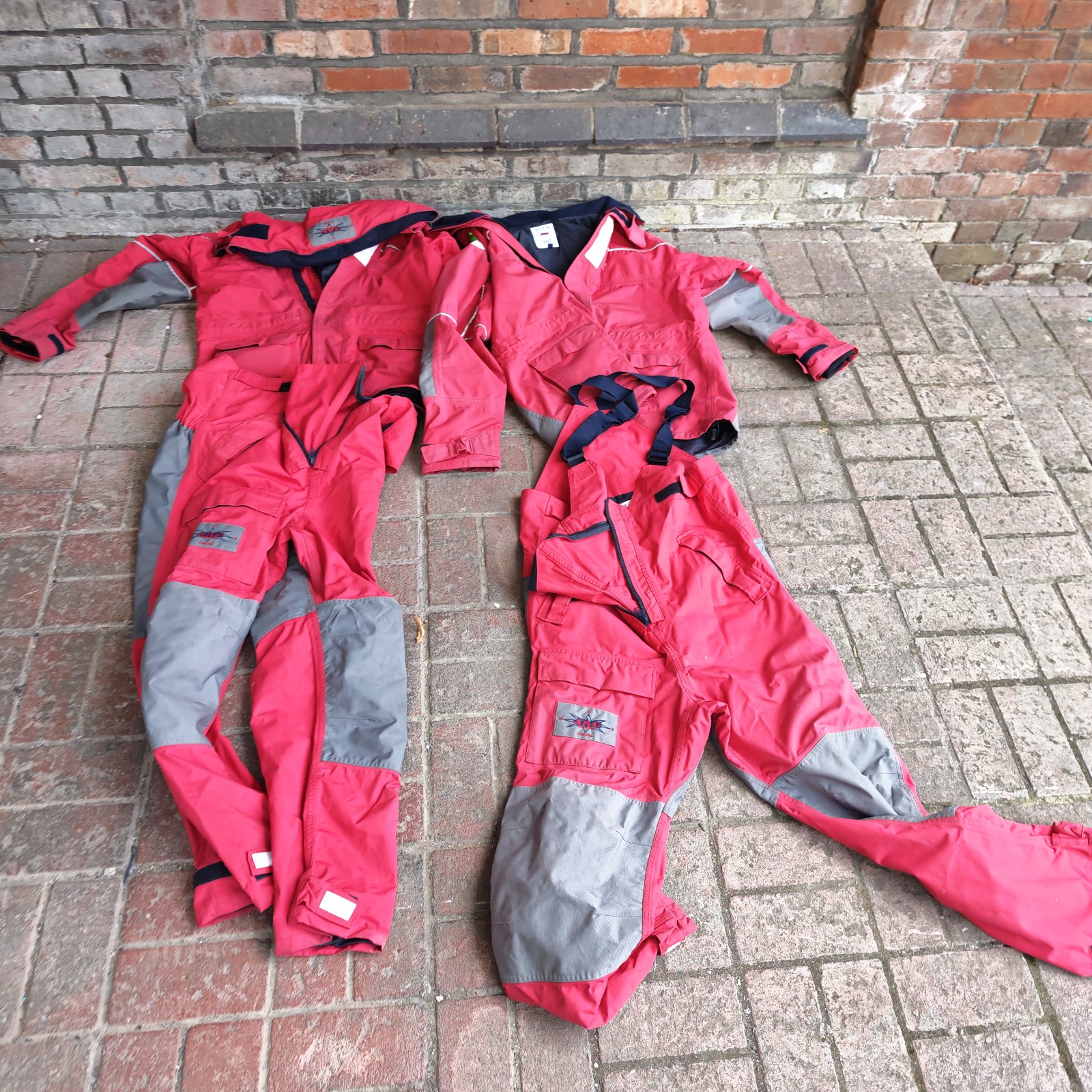 Red and grey JAG sailing suit set for outdoor water sports.
