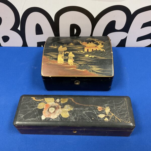 Vintage Japanese lacquered boxes with landscape scenes.