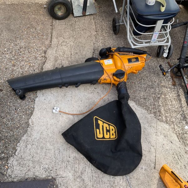 Side view of a used JCB lawn vacuum for garden cleaning.