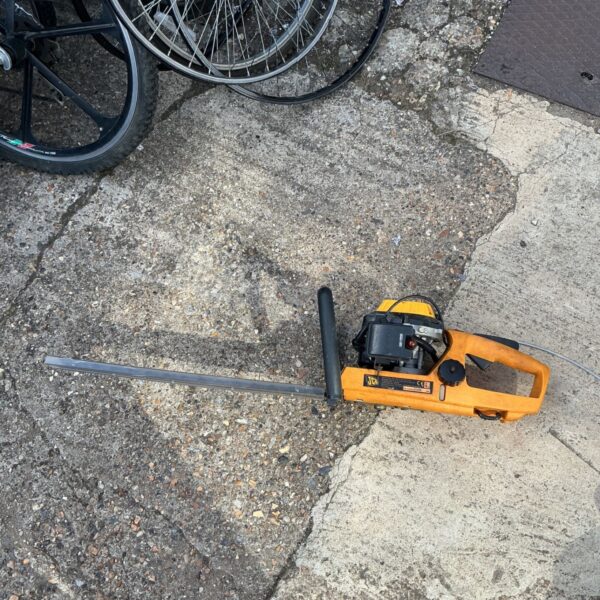 Used JCB petrol hedge trimmer for garden landscaping.