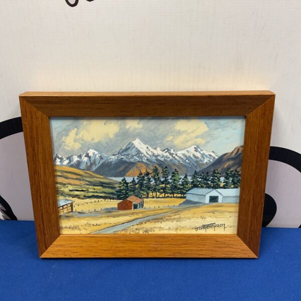 J G Thompson oil painting of a peaceful farm scene with mountains.