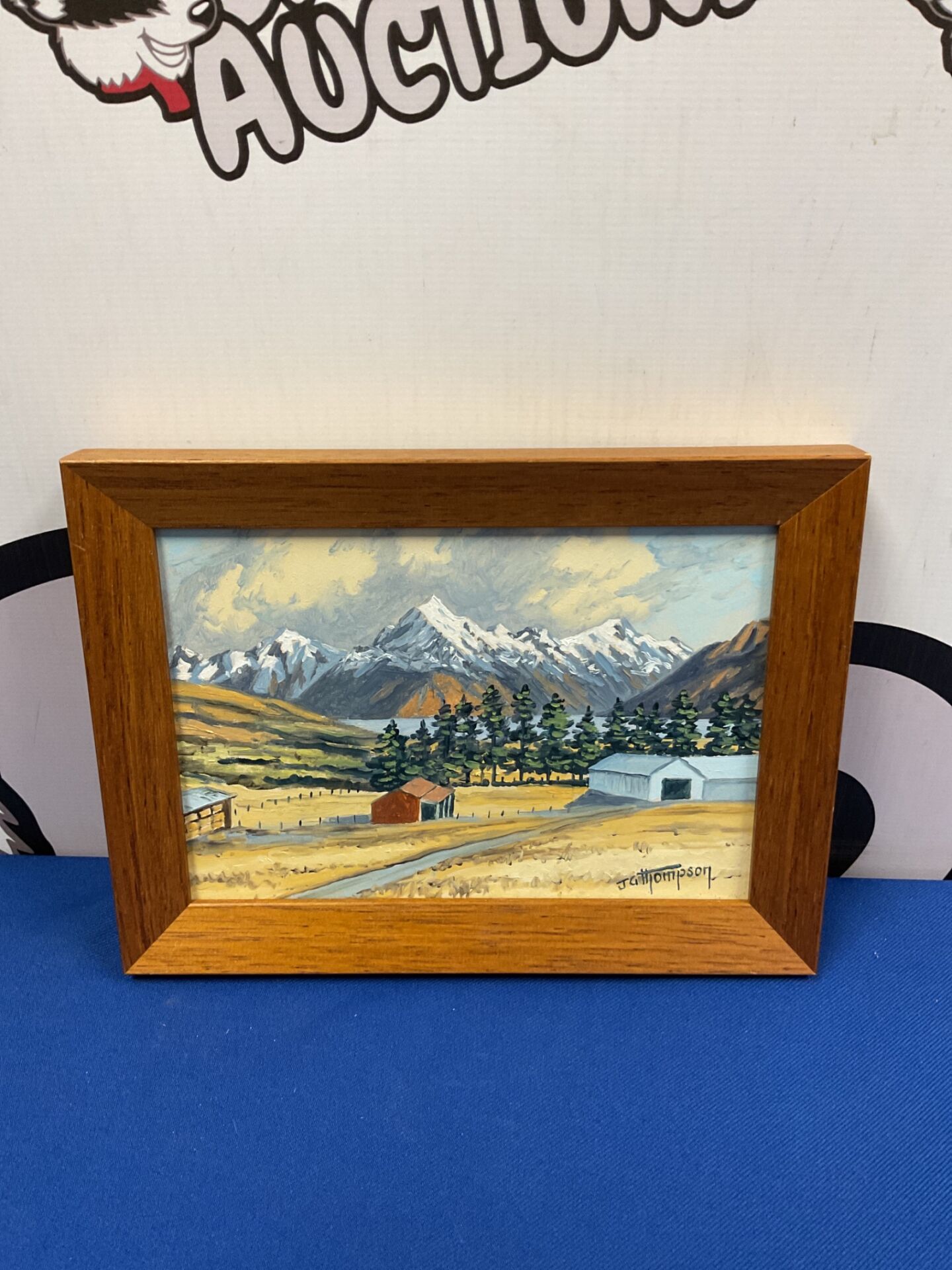 036 J g thompson oil on board of a farm scene with mountains on horizon