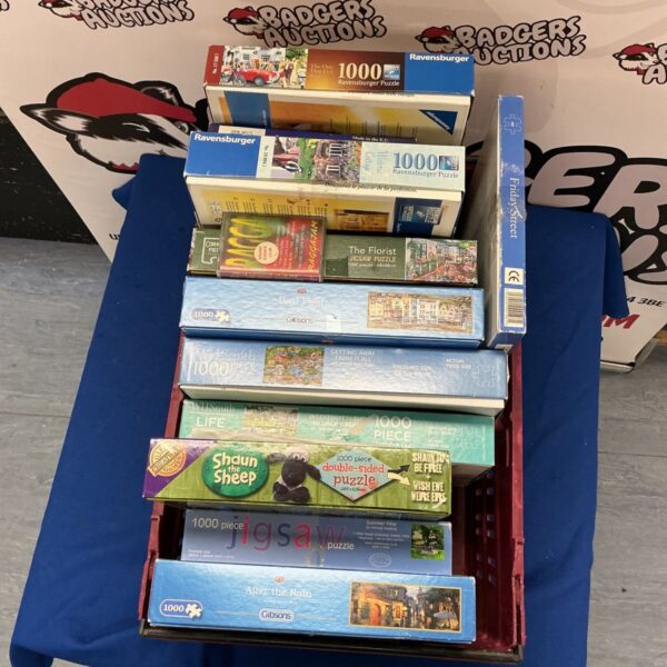 Assorted jigsaw puzzles including Ravensburger and Gibsons brands.