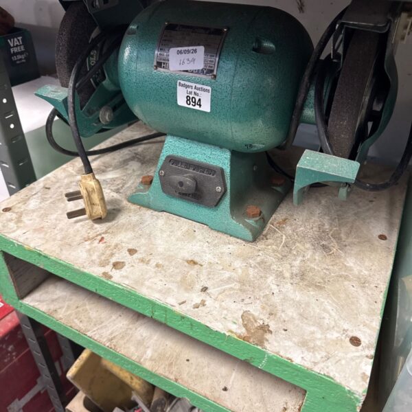 Vintage Kamasa bench grinder mounted on a wooden board.