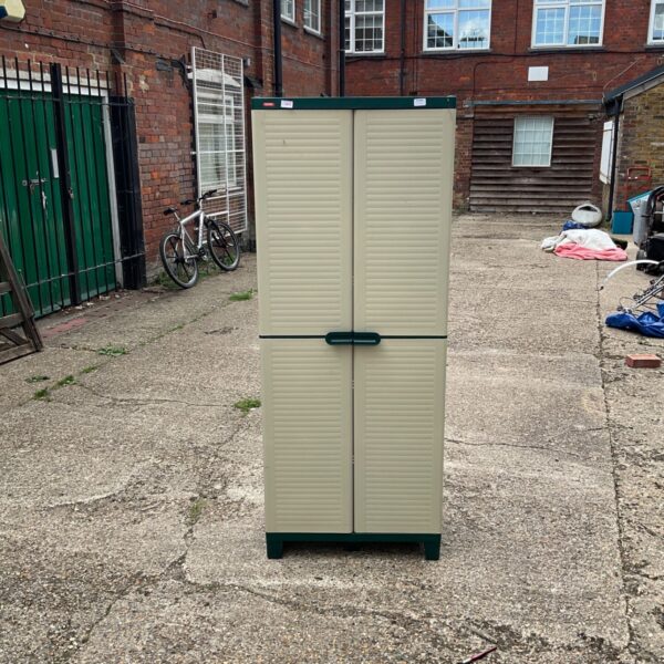 Beige and green Keter garden storage cabinet in an outdoor setting.