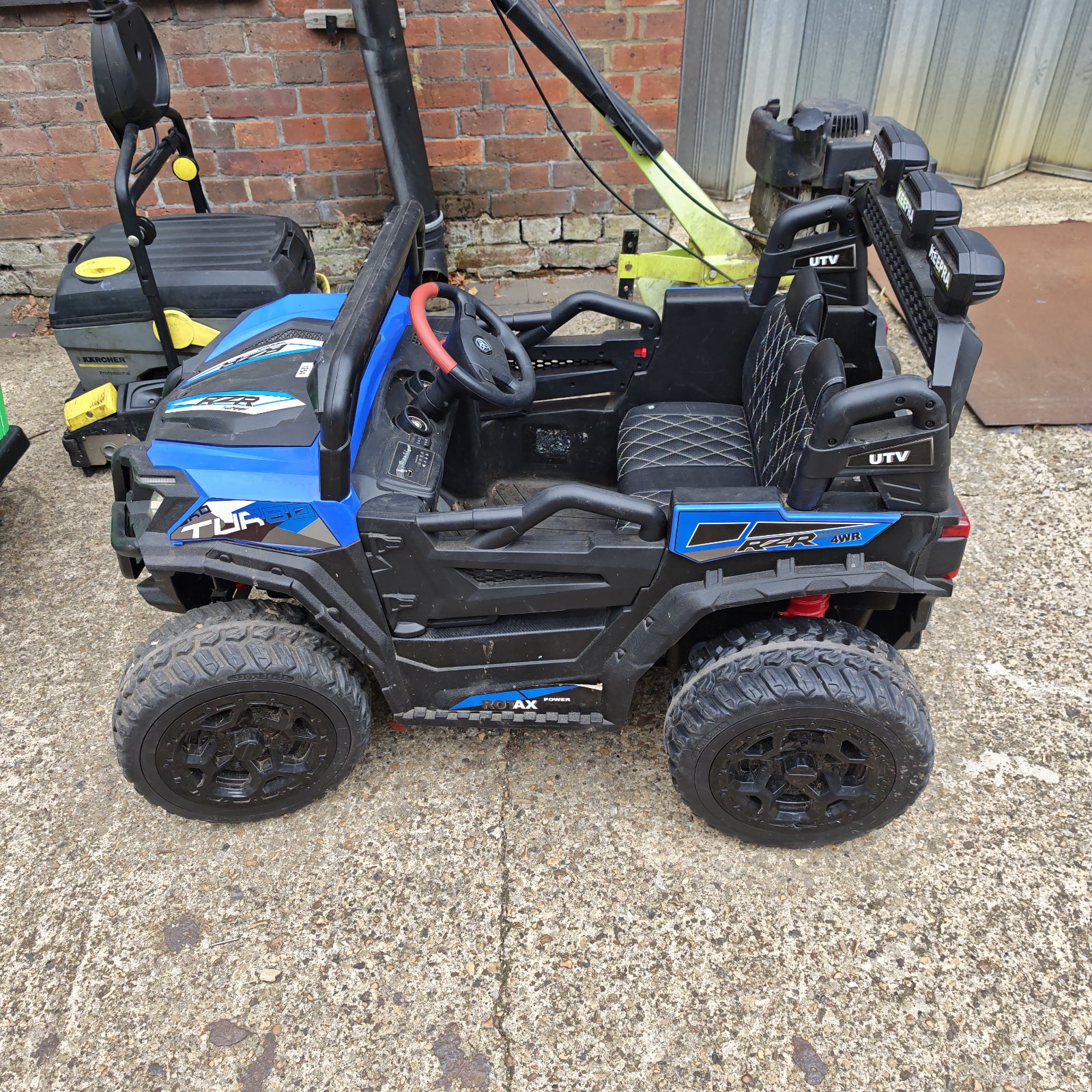 Red battery powered kids ride on jeep UTV toy.