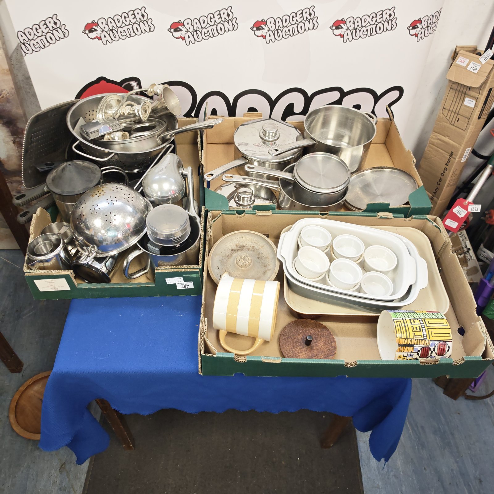 Mixed lot of stainless steel kitchenware including strainers and jugs.