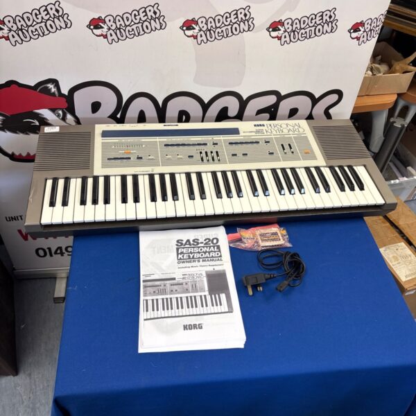 Vintage Korg SAS-20 keyboard with manual and cartridge.