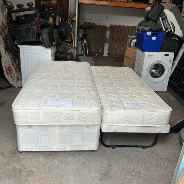 Kozeesleep guest bed in a cluttered garage setting.