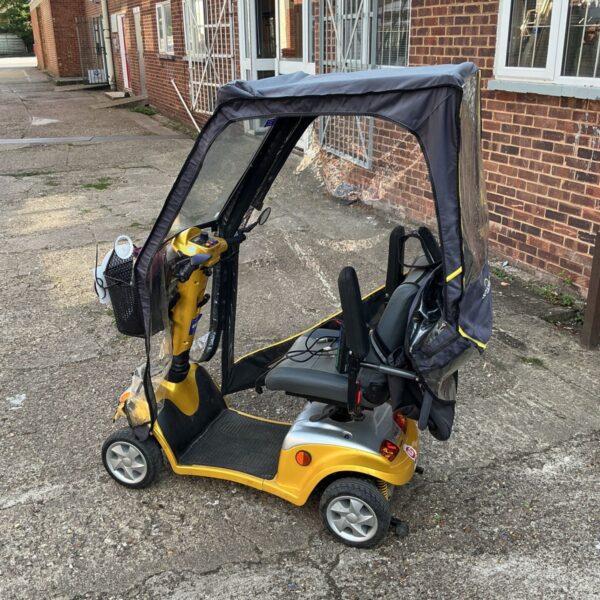 Yellow Kymco Super 8 electric mobility scooter with canopy.