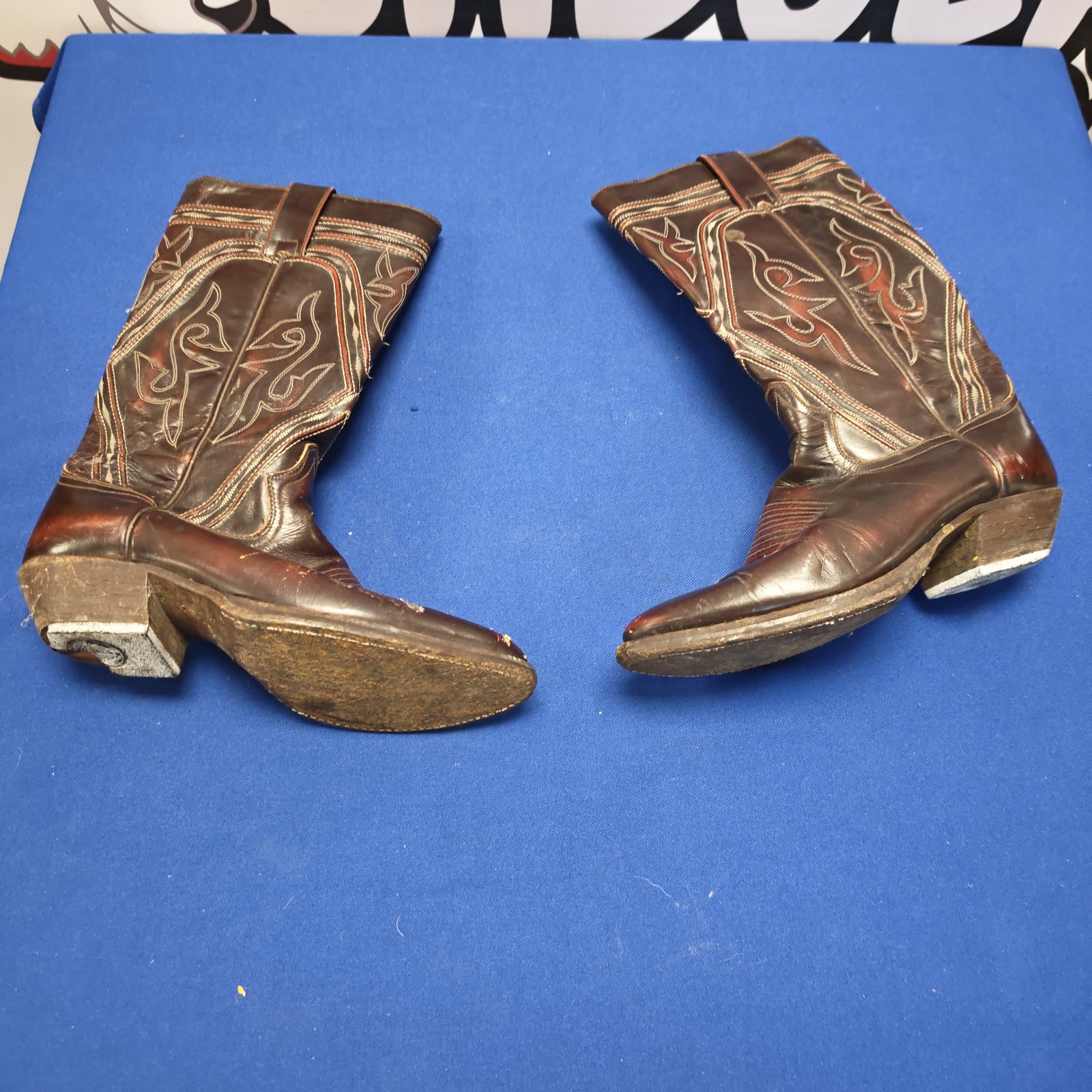 Vintage brown leather ladies cowboy boots needing heel repair.