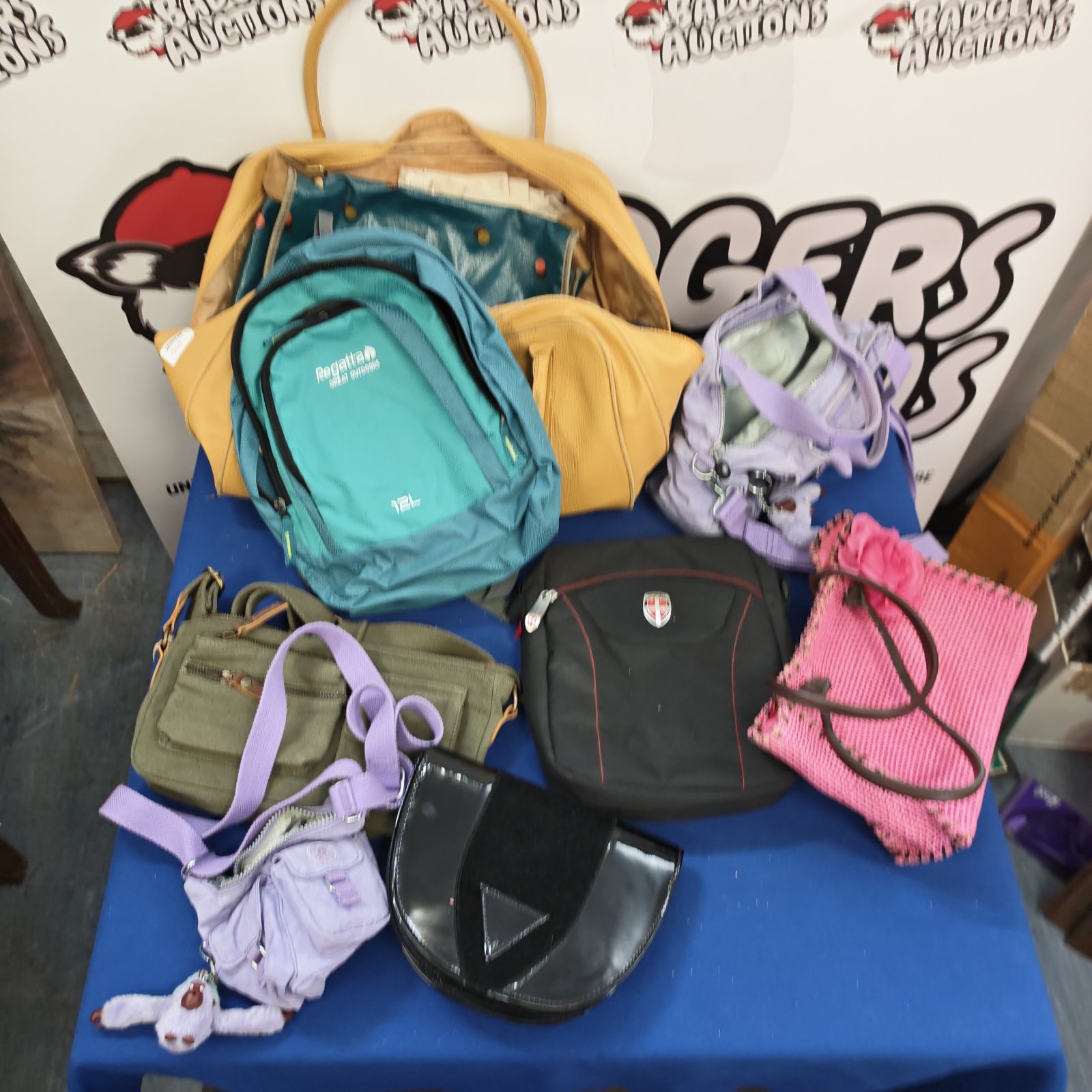 Ladies handbags and bags lot including Kipling and Estée Lauder brands.