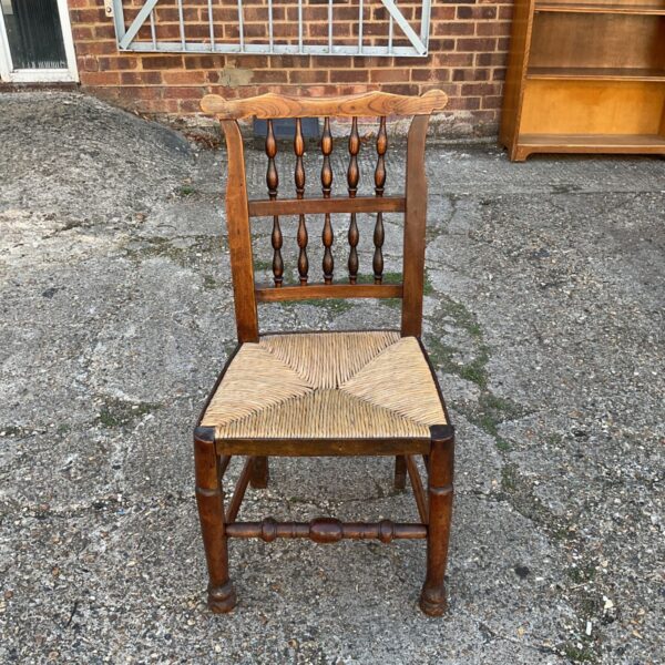 Antique Lancashire oak chair with woven rush seat, rustic country style.