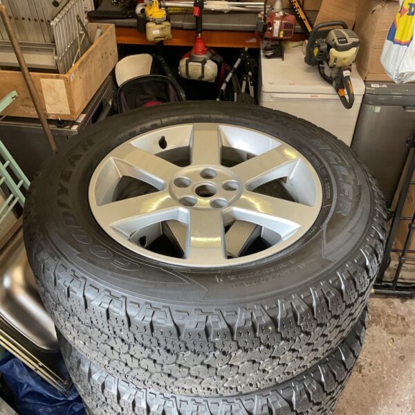 Silver Land Rover Defender wheel with Goodyear tyre.