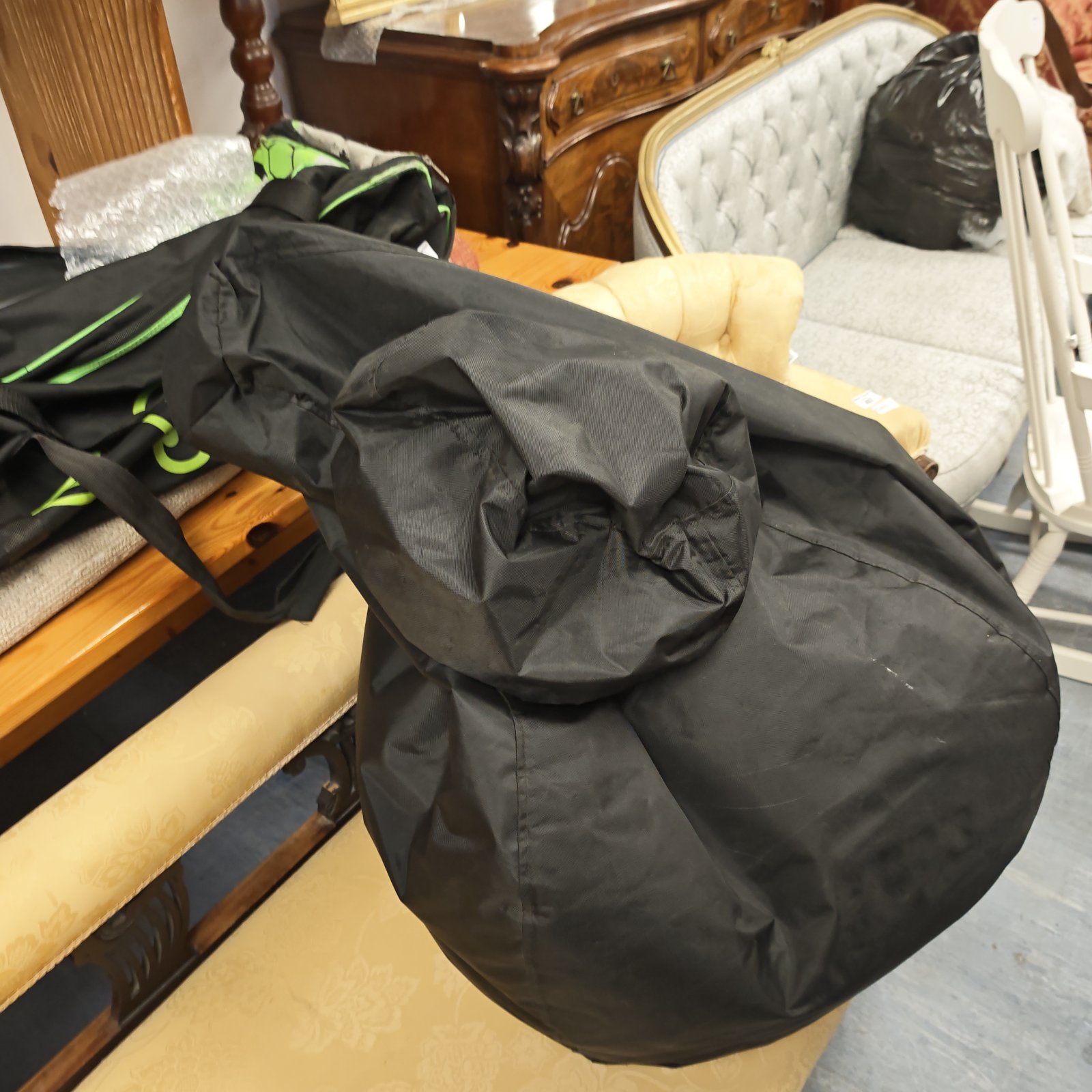 Large black bean bag chair for comfortable lounge seating.