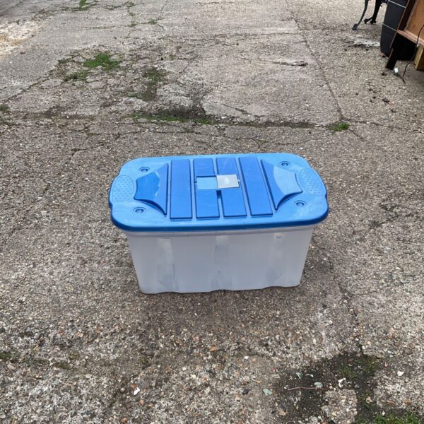 Large white plastic storage container with a blue lid.