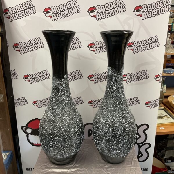 Large terracotta vases with black and silver speckled finish.