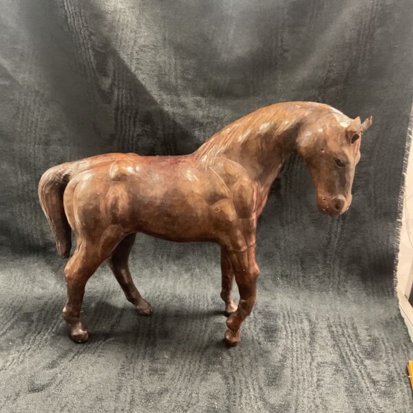 Antique leather horse sculpture with glass eyes, circa 1930.