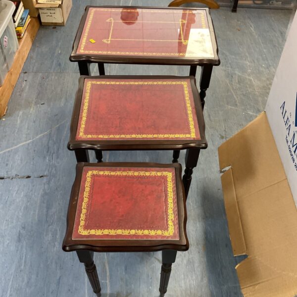 Vintage leather top nest of tables with mahogany frames.