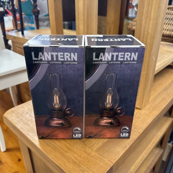 Pair of new dimmable LED lanterns in packaging.