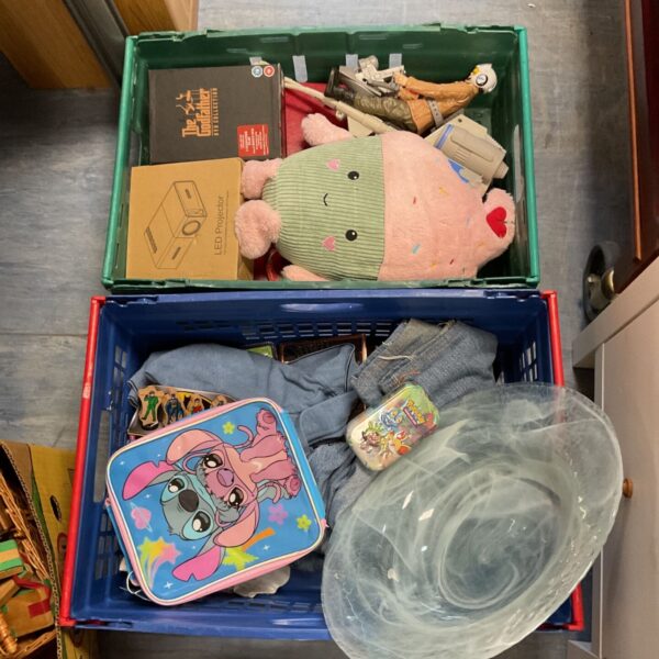 LED projector within a mixed lot of items, including DVDs and toys.