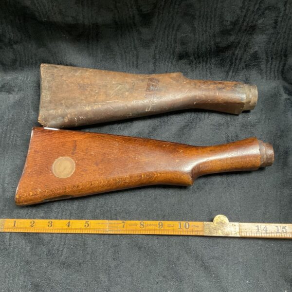 Vintage Lee Enfield gun stock with metal band.
