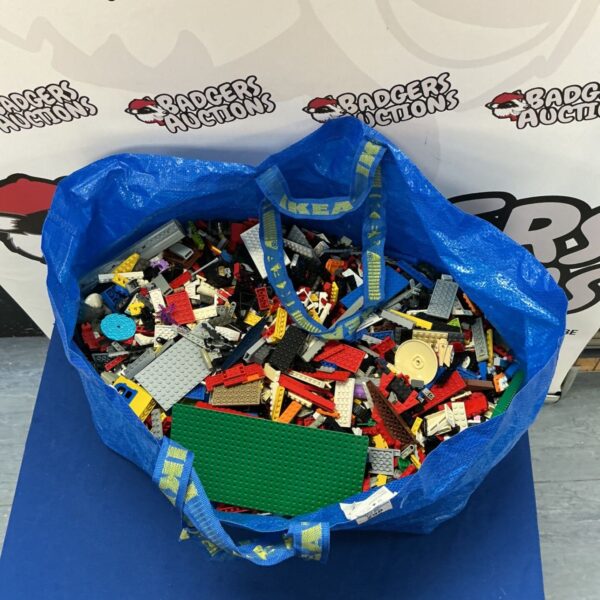 Blue bag filled with a large assortment of colourful Lego bricks.