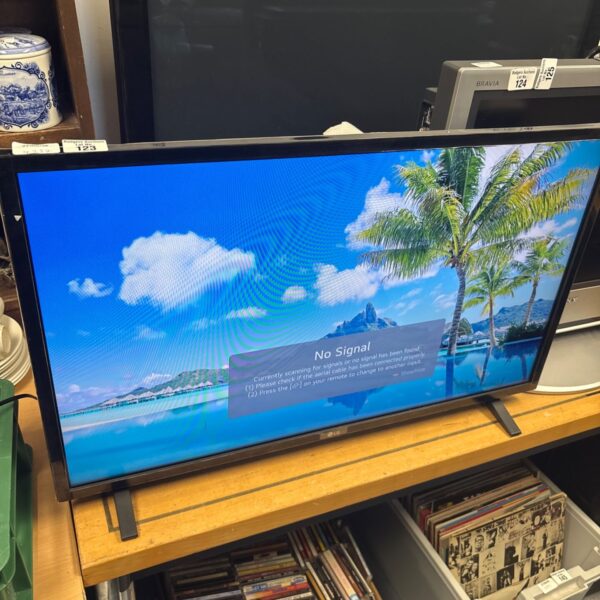 LG 32 inch flat screen TV with remote control for home entertainment.