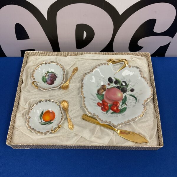 Antique Limoges fruit service set with gold spoons and painted fruit.