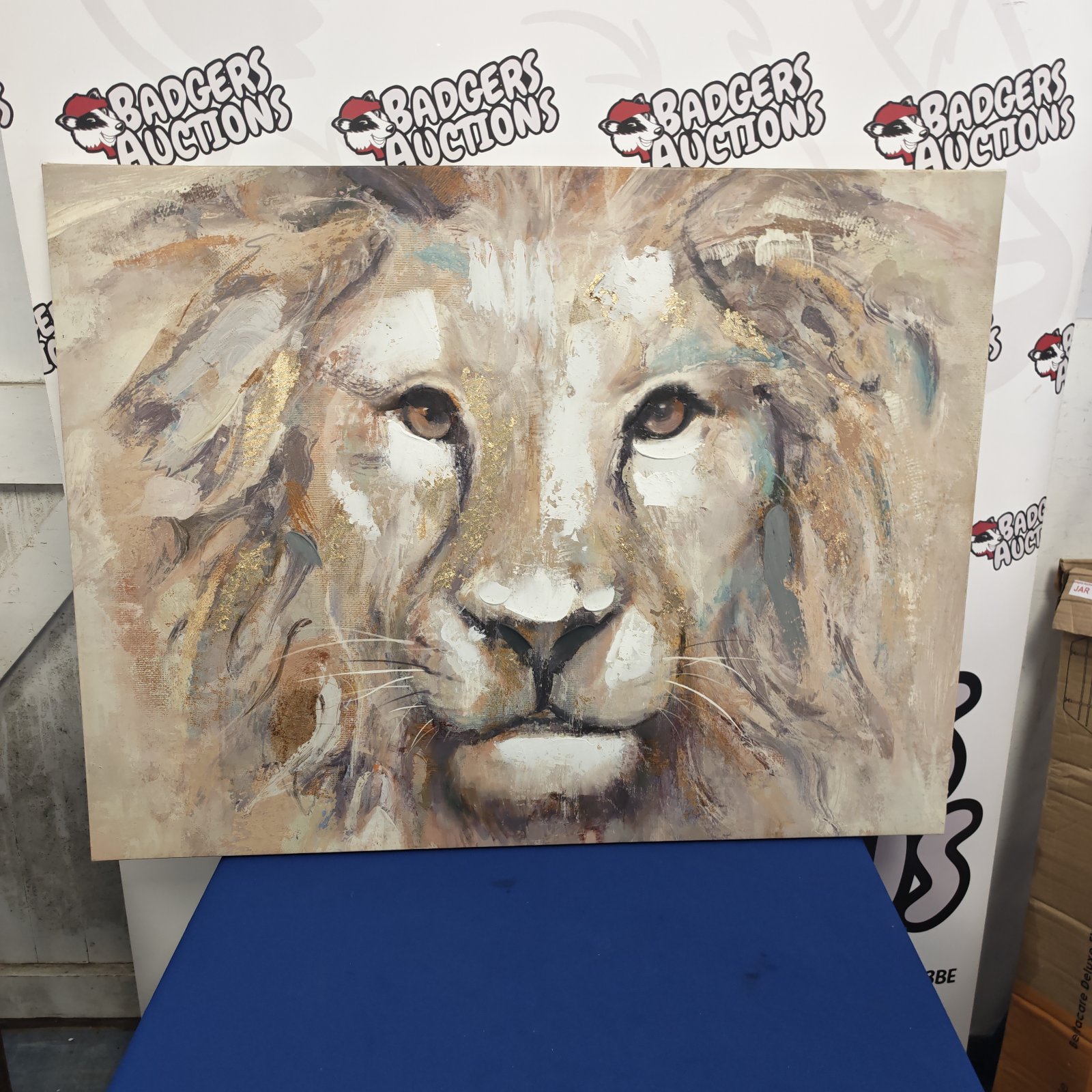 Large canvas print of a lion's head with gold detailing.