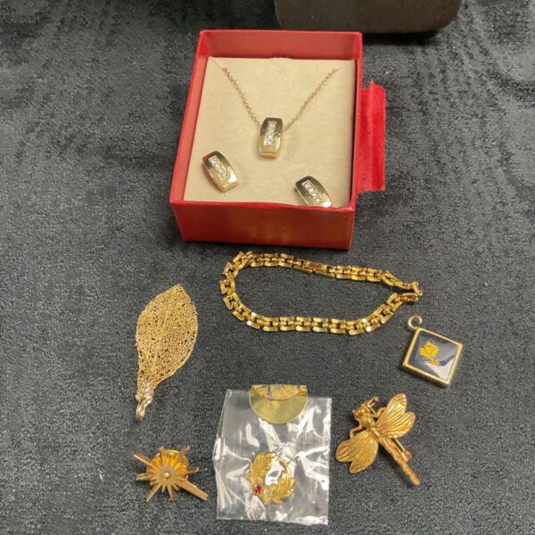 Tub of yellow metal jewellery Inc secret dreams made with Swarovski elements